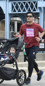 Harold runs with his son Gabe in the stroller